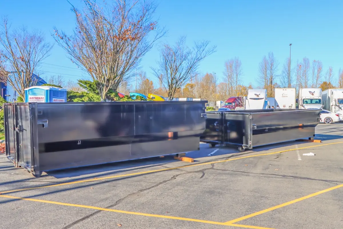 Professional dumpster rental service with roll-off container on residential driveway in Runnemede